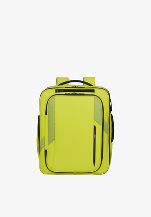 Bright yellow square backpack with black zippers, front pockets, mesh details, top handle, and padded shoulder straps.