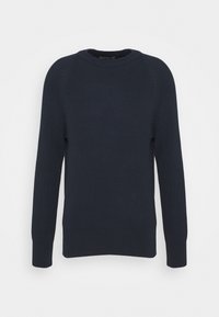 Marineblå ribbad stickad tröja med rund halsringning, långa ärmar och avslappnad passform. Har texturerat tyg och minimala design detaljer.