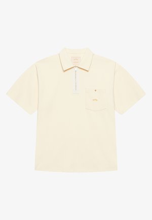 Short-sleeve polo shirt in pale yellow fabric, featuring a zippered collar, chest pocket with a gold button, and subtle logo detail.