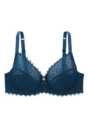 Bralette en dentelle d'un vert profond avec des motifs géométriques, des bords festonnés et un petit accent décoratif doré au centre. Bretelles ajustables.