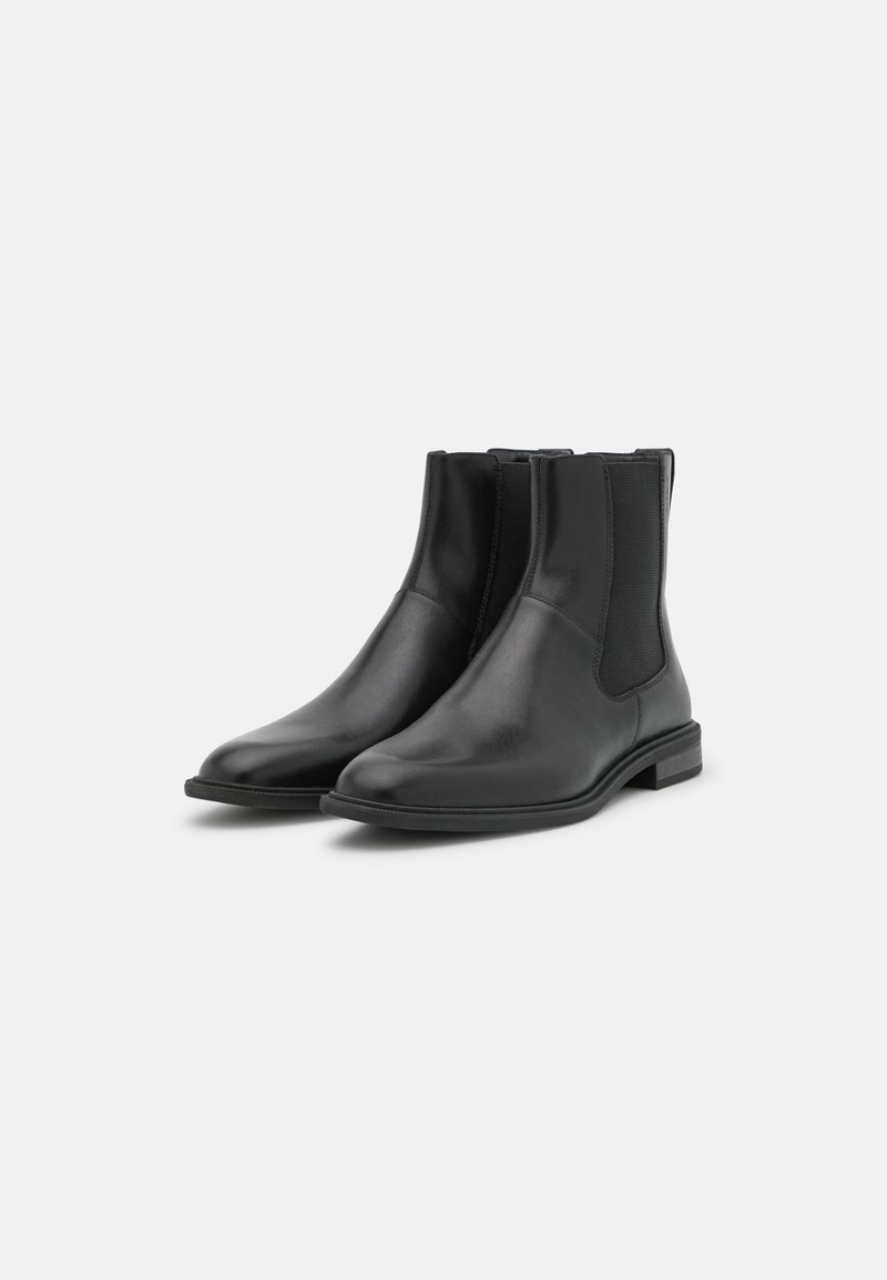 Zwarte leren Chelsea boots met elastische zijk anten, ronde neus, lage gestapelde hak en een gladde textuur. Klassiek ontwerp op enkelhoogte.