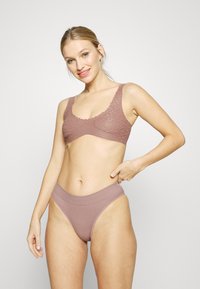 Lyserosa bralette med bølget kant og teksturert mønster; matchende høy midje sømløs truse med myk, elastisk midje.