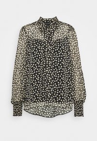 Blusa nera trasparente con pois bianchi, apertura frontale con bottoni, colletto con fiocco e polsini elasticizzati. Tessuto leggero con un design fluido.