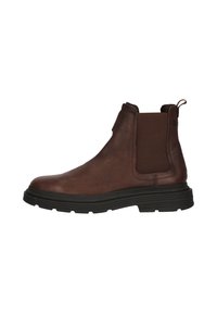 Bruine leren Chelsea-boot met elastische zijpanelen, ronde neus, gestructureerde bovenkant en dikke zwarte rubberen zool. Naaddetails op de schacht.