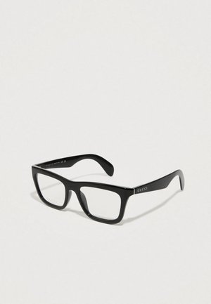 Gafas de lectura rectangulares negras con un acabado brillante, con lentes transparentes y la marca "GUCCI" en la patilla. Acabado de plástico suave.