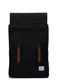 Black fabric backpack with a roll-top design, brown leather accents, front zippered pocket, and a logo patch on the lower front.