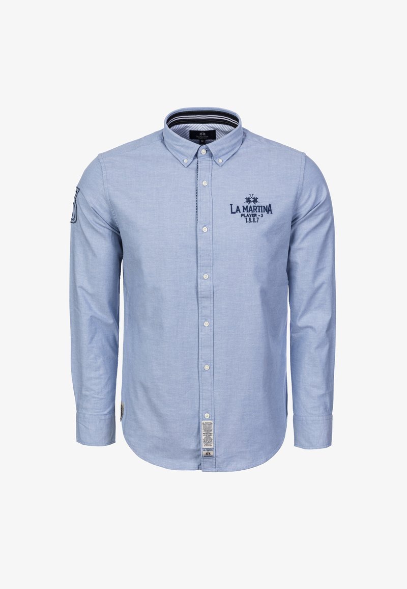 Light blue button-up shirt made of soft fabric, featuring long sleeves, a collar, embroidered logo, and a tag at the bottom side.