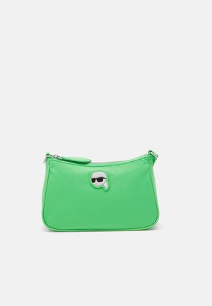 Bright green small handbag with a top zipper and a small patch of a person wearing black sunglasses on the front center.