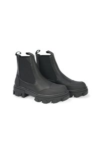 Schwarze Leder Chelsea-Stiefel mit robuster Gummisohle, elastischen Seitenpaneelen, Ziehschlaufen und strukturiertem Finish. Robustes und modernes Design.