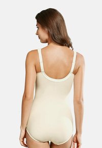 Beige one-piece bodysuit with adjustable straps, smooth texture, and a round back design. Features a full coverage cut.