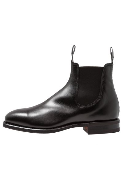Black leather Chelsea boot with elastic side panels, smooth finish, rounded toe, and a low stacked heel. Features pull tabs for easy wear.