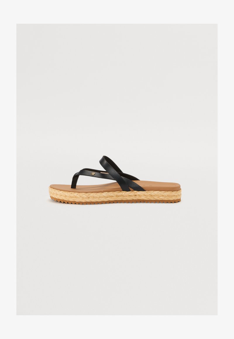 Black leather flip-flop sandal with crossed straps, tan footbed, and woven jute platform sole. Rubber outsole with textured pattern for grip.