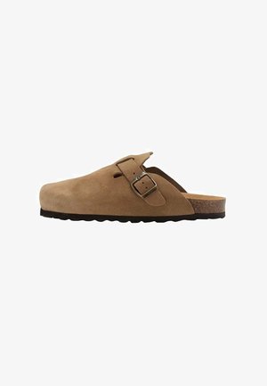 Brown suede clog with a buckle, featuring a cushioned cork footbed and textured rubber sole, designed for comfort and easy wear.