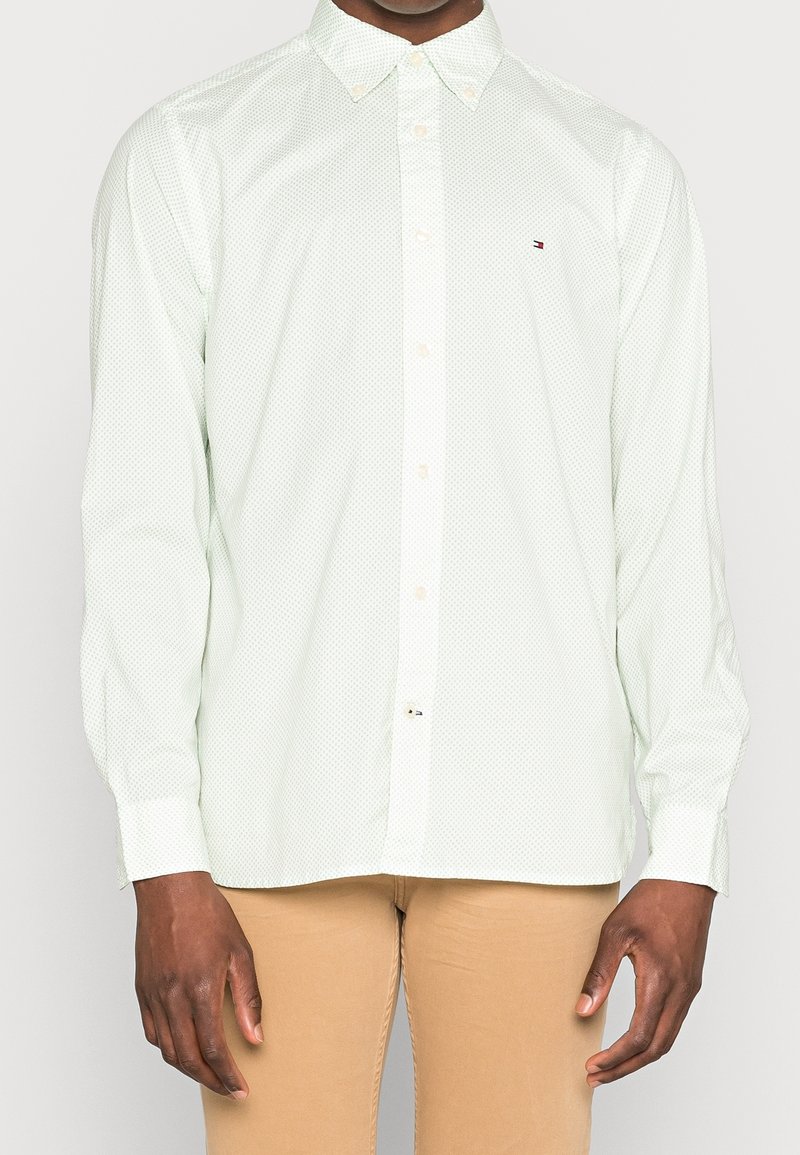 Hellgrünes Hemd mit weißen Punkten, klassischem Kragen, langen Ärmeln und kleinem Logo auf der Brust. Material aus Baumwollmischung.