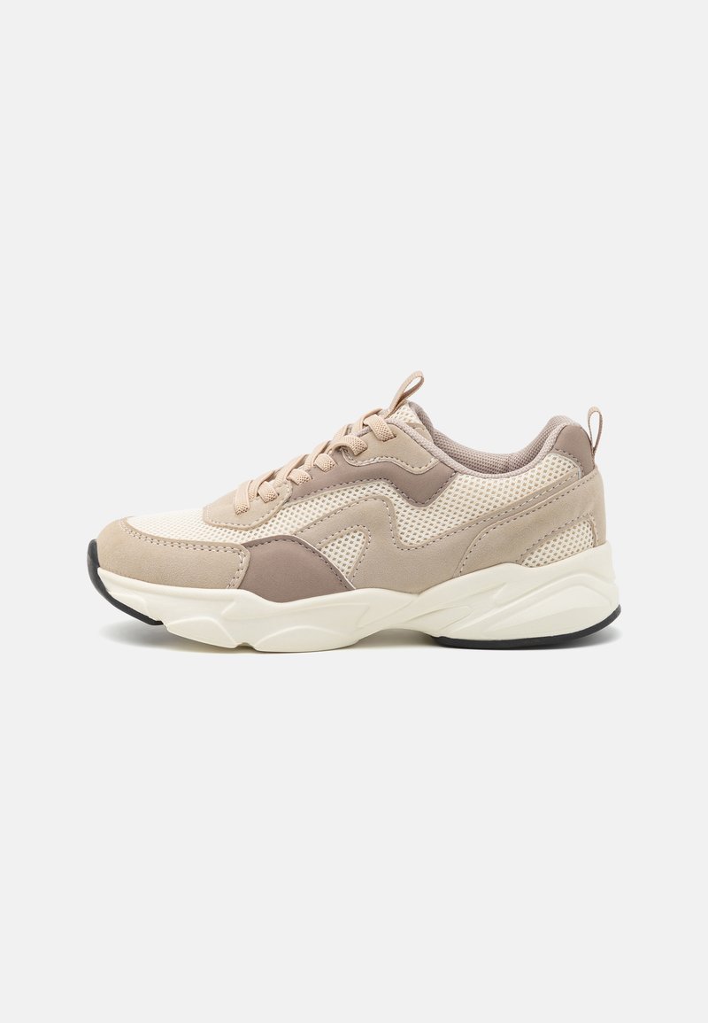 Beige athletic sneakers featuring a mesh and suede textured upper, rounded toe, lace-up design, and a thick, white rubber sole.