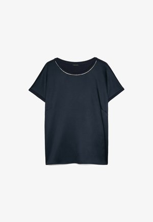 Marineblaue Kurzarmbluse mit rundem Ausschnitt und dezentem silbernem Kettendetail am Kragen, dargestellt auf weißem Hintergrund.