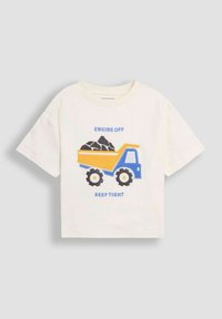Bavlněné tričko, krémové barvy, s modrožlutou grafikou sklápěče, černými pneumatikami a textem "MOTOR VYPNUTÝ BIP TĚSNĚ." Krátké rukávy.