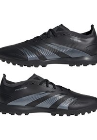 Black artificial leather football shoes with grey accents, textured surface, and rubber studs for grip. Features a lace-up closure and padded collar.