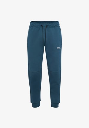 Pantalons de survêtement vert foncé en tissu doux, dotés d'une taille élastique avec cordon de serrage, de jambes fuselées et de détails en panneau au niveau des genoux.