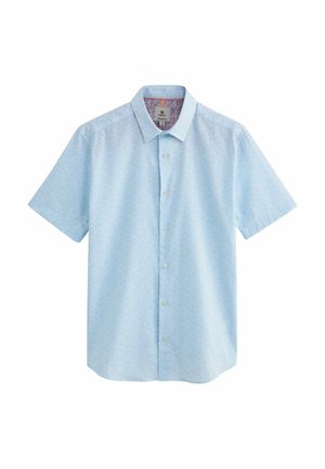 Chemise bleu clair à manches courtes avec boutons, motif subtil et col classique, étiquetée taille moyenne.
