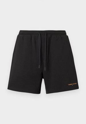 Schwarze Shorts aus weichem Stoff mit einem elastischen Bund und einem Kordelzug sowie einem kleinen orangefarbenen "TOMMYJEANS"-Logo am Saum.