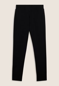 Leggings negros fabricados con tejido elástico, con una pretina sin costuras y una textura suave, diseñados para ofrecer comodidad y flexibilidad.