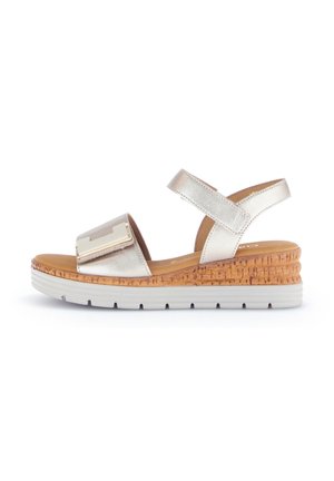 Metallic gold wedge sandals with a cork base, wide strap featuring a decorative hardware accent, and adjustable ankle strap.