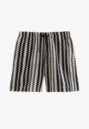 Zwart-witte zigzag gebreide shorts met een elastische tailleband en zwarte aantrekkoorden aan de voorkant.