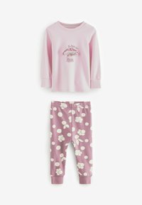 Chemise rose pâle à manches longues avec imprimé champignon et leggings à pois blancs sur fond rose, fabriqués en tissu doux pour plus de confort.
