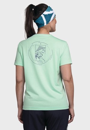 Mintgrünes T-Shirt mit kurzen Ärmeln und einem navyfarbenen Grafikdesign eines Blumenmotivs und Linien auf dem Rücken. Glatter Stoff und lockere Passform.