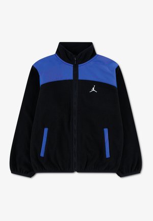 Veste zippée noire et bleue avec col montant, poignets élastiques, deux poches avant et un logo Jumpman blanc sur la poitrine.