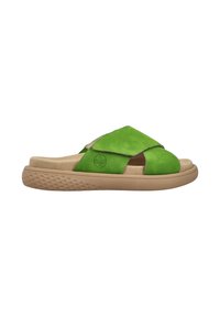 Green suede slide sandals with a cross-over design and tan rubber sole, featuring textured grip and a logo embossed on the side.