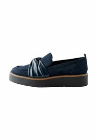 Navy suede slip-on shoe with a glossy black knot accent, featuring a thick black platform sole and cushioned insole for comfort.