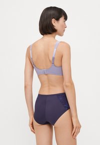 Lilac bra with adjustable straps and a smooth finish, paired with dark purple briefs featuring lace accents on the sides.