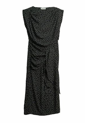 Sort ærmeløs midi-kjole med hvide polkaprikker, draperet front og detaljer med bindebånd i siden.