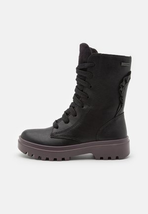 Black ankle boot with a textured leather upper, lace-up design, cushioned collar, and a rugged purple sole with traction grooves.