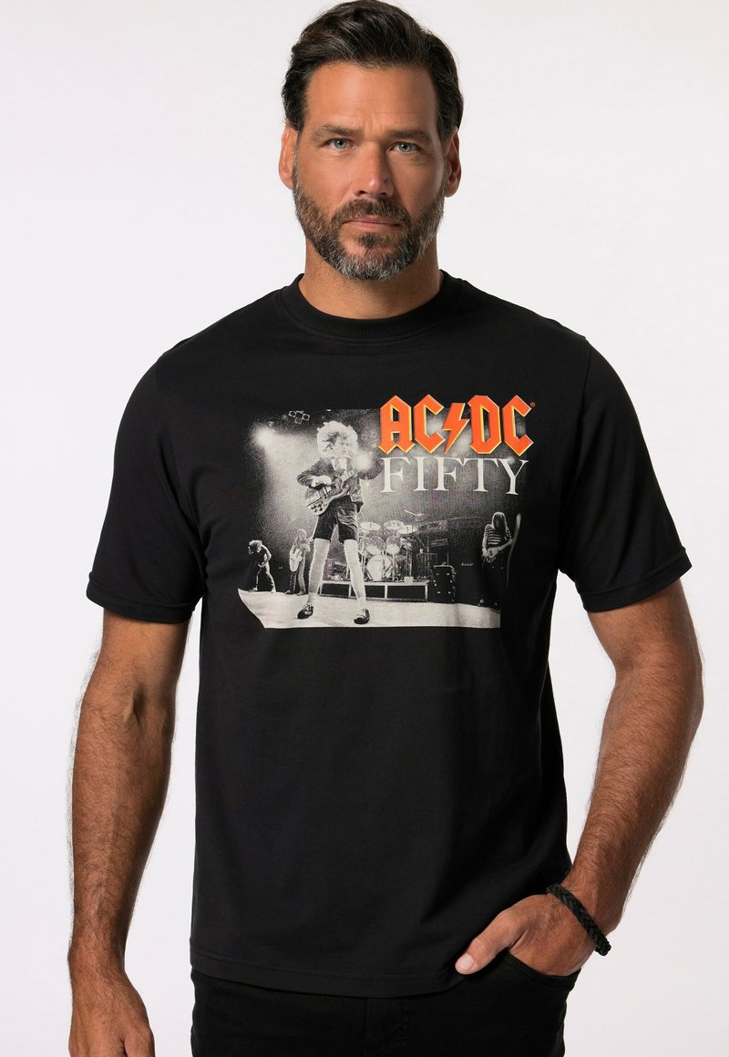 Černé bavlněné tričko s grafikou AC/DC, s nápisem "FIFTY" v oranžovém písmu. Design zahrnuje koncertní scénu v odstínech šedi jako centrální detail.