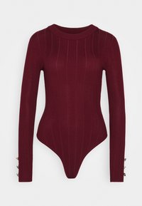 Body manches longues bordeaux avec texture côtelée, encolure ronde et accents décoratifs de boutons sur les manches. Coupe ajustée avec une partie inférieure string.