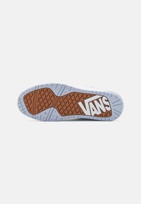 Sole of a Vans sneaker featuring a brown rubber outsole with diamond tread pattern, white logo, and light blue accents.