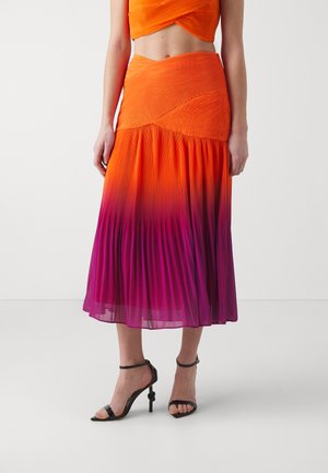 Orange to purple gradient pleated midi skirt made of lightweight fabric, featuring a fitted waist and flowy hemline. Paired with black heels.