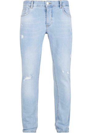 Jeans in denim azzurro chiaro con vestibilità slim, caratterizzati da dettagli strappati sulle ginocchia e design a cinque tasche standard.
