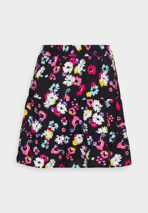 Black cotton skirt with a floral pattern featuring pink, white, yellow, and blue flowers. It has tiered ruffles and an elastic waistband.