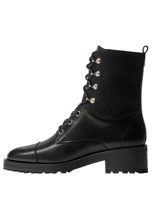Bottine noire en cuir avec talon bloc, devant à lacets avec œillets dorés et partie supérieure texturée avec languette à l'arrière.