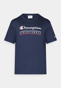 Navy blue cotton T-shirt with a crew neckline, featuring white and red "Champion ATHLETICWEAR" text graphic across the chest. Short sleeves.