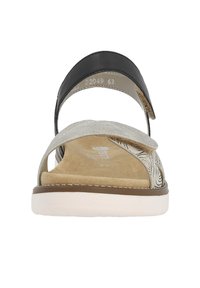 Sandale noire et argentée avec un dessus texturé orné de motifs décoratifs, semelle intérieure rembourrée et semelle extérieure blanche. Design à bout ouvert.