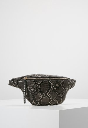 Black and gray snakeskin-patterned waist bag with a front gold zipper and adjustable strap on a white pedestal.