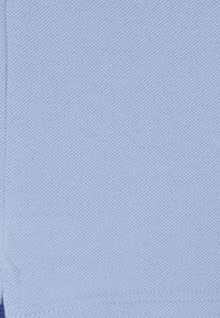 Hellblauer, strukturierter Stoff mit einem gestrickten Muster, der eine glatte Oberfläche und saubere Kanten aufweist. Geeignet für Kleidung oder Accessoires.