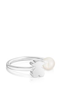 Anello in argento con un dettaglio a forma di orso e una perla bianca. Superficie liscia e lucida con un design semplice ed elegante.