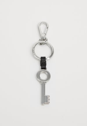 Key-shaped metal keychain with a polished silver finish, attached to a black leather strap and a silver circular ring with a clip.