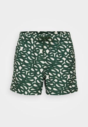 Green and white swim shorts featuring a wavy patterned design, elastic waistband with drawstring, and soft fabric for comfort.
